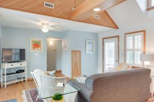 een woonkamer met een bank en een tv bij Courtyard Villas on Silver Lake in Ocracoke