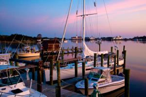 a group of boats docked at a dock at Courtyard Villas on Silver Lake in Ocracoke