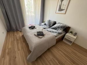 a bedroom with a bed with two towels on it at Kotlina Kłodzka - Apartament na Letniej in Kłodzko