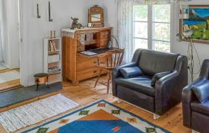 a living room with a chair and a desk at 2 Bedroom Cozy Home In Kisa in Kisa