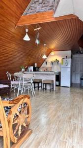 a kitchen and dining room with a table and refrigerator at Cabaña María in Siguatepeque