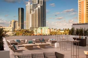 a rooftop patio with couches and a city skyline at Residence Inn Miami Sunny Isles Beach in Miami Beach