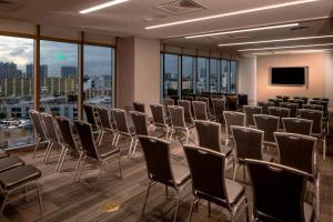 a conference room with chairs and a flat screen tv at Residence Inn Miami Sunny Isles Beach in Miami Beach