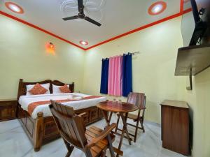 a bedroom with a bed and a table and chairs at The Kukas Resort in Jaipur