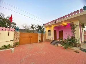 a house with a brick driveway in front of it at The Kukas Resort in Jaipur