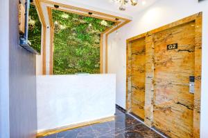 a bathroom with a wooden door and a window at Hotel Gorrion in Mumbai