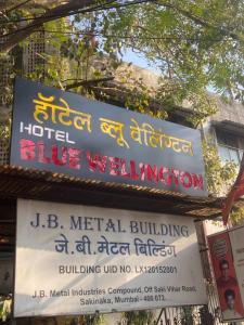 Hotel Blue Wellington - Near Mumbai Airport في مومباي: علامة على تجمع المياه الزرقاء في الفندق