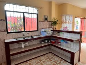 cocina con fregadero y ventana en Casa de Huéspedes Paola en Puerto Baquerizo Moreno