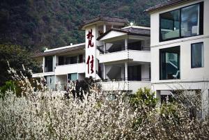 a building with a sign in front of it at Fanzhu Hotel in Xingyi