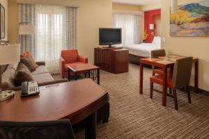 a hotel room with a living room with a couch and a bed at Residence Inn by Marriott Helena in Helena