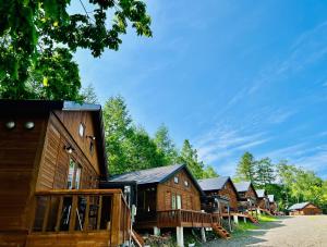 a row of wooden cabins in a row at Shirakaba no mori Cottage - Vacation STAY 90794v in Abashiri