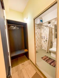 a bathroom with a shower and a glass door at Irroi Guwahati in Guwahati