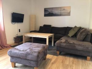 a living room with a couch and a table at Holiday home Am Beulskopf in Hemmelzen