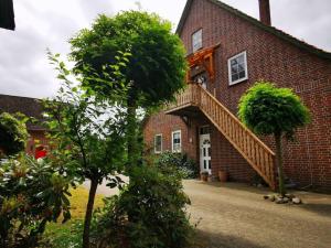 a brick house with a staircase on the side of it at Sophienhof Lieselotte in Neuenkirchen
