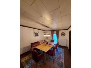 a dining room with a table and chairs and a couch at Holiday house on Bornfeld in Leimen +34 photos