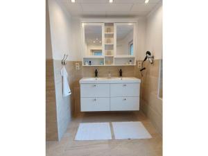 a bathroom with a white sink and a mirror at Holiday house on Bornfeld in Leimen