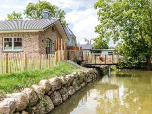a house with a bridge over a river at Holiday home Small Island in Fehmarn