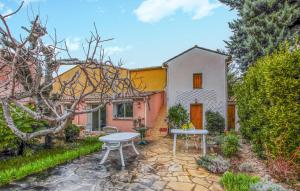 a garden with a table and chairs in front of a house at Amazing Home In Nyons With Wi-Fi in Nyons +12 photos