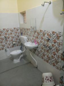 a bathroom with a toilet and a sink at Dey Niwas in Dum Dum