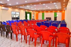 an empty room with red chairs and blue chairs at Hotel Jiyan Hospitality Pvt. Ltd. in Dhangadhi
