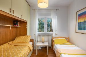 um quarto com 2 camas e uma janela em Apartman Lavanda em Kostrena