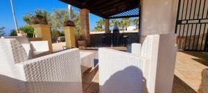 a group of white fences in front of a house at Villa Marchese with private pool in Gallipoli +7 photos