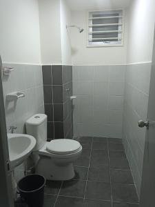 a bathroom with a toilet and a sink at Homestay Melody Puncak Alam in Bandar Puncak Alam