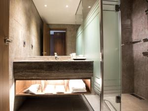 a bathroom with a sink and a shower at Grabel Hotel Jeju in Jeju