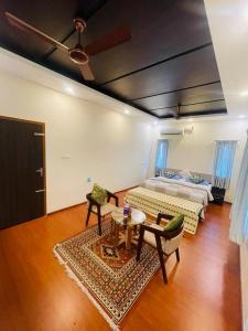 a living room with a bed and a table at Castle Villa in Ernakulam