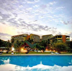 a resort with a swimming pool in front of a building at Restful Beach Front studio-Diani in Diani Beach
