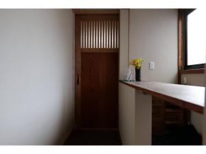 a room with a door and a counter with flowers at YAKATA - Vacation STAY 58595v in Yuzawa