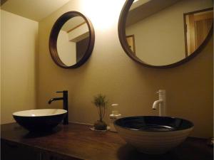 a bathroom with a sink and a large mirror at YAKATA - Vacation STAY 58595v in Yuzawa