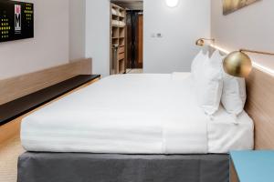 Postel nebo postele na pokoji v ubytování M Hotel Al Dana Makkah by Millennium