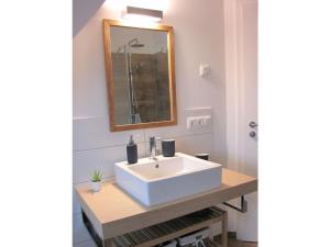 a bathroom with a white sink and a mirror at Thatched cottage Starfish in Zierow +20 photos