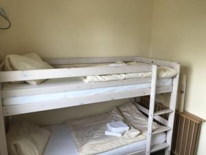 two bunk beds in a room with towels on them at Holiday home Lilly in Staberdorf