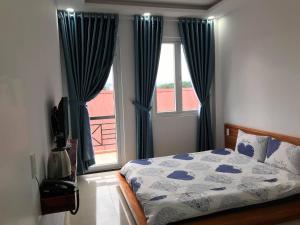 Postel nebo postele na pokoji v ubytování Ha Khoa Hotel Dalat