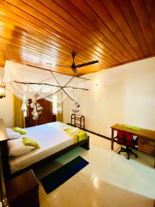 a bedroom with a bed and a wooden ceiling at The beach gate villa in Beruwala