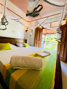 a bedroom with a bed with a towel on it at The beach gate villa in Beruwala