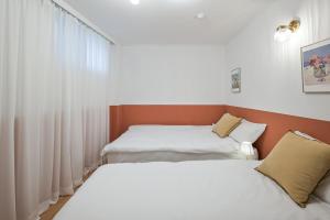 Postel nebo postele na pokoji v ubytování SSH Myeongdong Dongdo Hostel