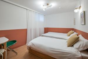 Postel nebo postele na pokoji v ubytování SSH Myeongdong Dongdo Hostel