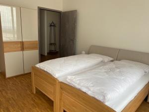 a bedroom with a large bed with white sheets at Suite 32 in Oerlinghausen