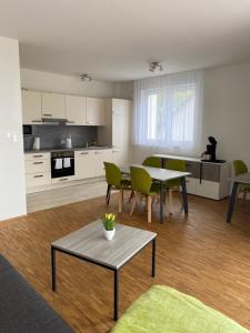 a living room with a table and chairs and a kitchen at Suite 32 in Oerlinghausen