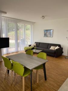 a living room with a couch and a table and chairs at Suite 32 in Oerlinghausen