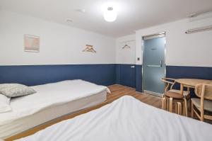 Postel nebo postele na pokoji v ubytování SSH Myeongdong Dongdo Hostel