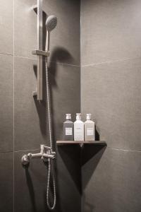 a bathroom with two bottles of soap and a microphone at SSH Myeongdong Dongdo Hostel in Seoul