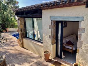 a stone house with a window and a patio at Vega in Begur