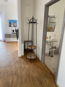 a room with a mirror and a stool and a sink at Penthouse 34 -rollstuhlgerecht- in Oerlinghausen