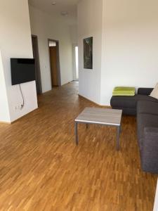 a living room with a couch and a coffee table at Penthouse 34 -rollstuhlgerecht- in Oerlinghausen