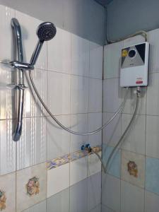 a shower with a blow dryer on a wall at Kohchang FuengFah in Ko Chang