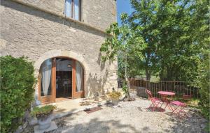 a patio with chairs and a table in front of a building at 3 Bedroom Gorgeous Home In Barjac in Barjac